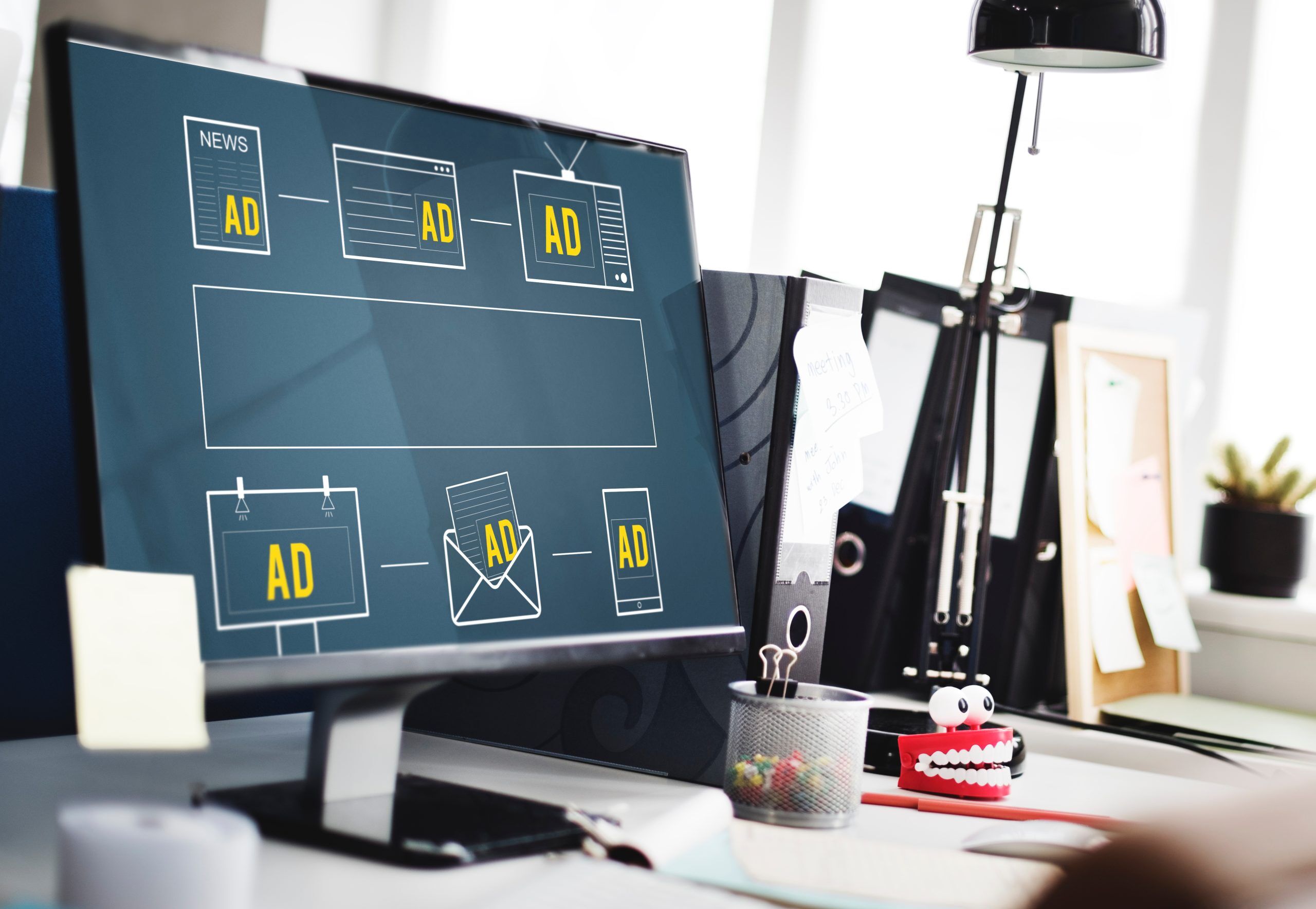 A computer screen with a dark blue-green background featuring illustrated icons of different ad types